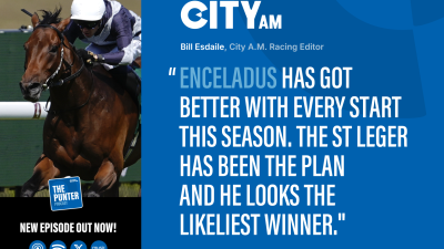 Jockey in white helmet and blue silks riding a racehorse in a CityAM racing article.