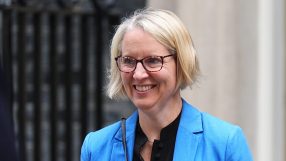 Emma Reynolds, a blonde woman in glasses and blue blazer, smiling outdoors