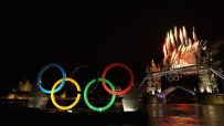 Olympic Rings display with fireworks over Tower Bridge and the River Thames at night, London.