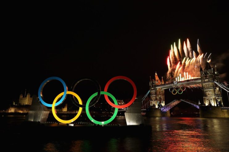 Olympic Rings display with fireworks over Tower Bridge and the River Thames at night, London.