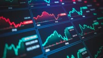 Digital display of stock market charts with fluctuating red and green lines, indicating financial data and trends