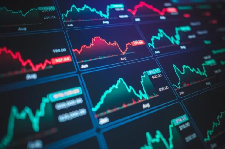 Digital display of stock market charts with fluctuating red and green lines, indicating financial data and trends