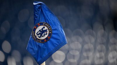 Close-up of a blue Chelsea Football Club corner flag with visible raindrops and the club crest.