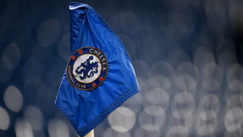 Close-up of a blue Chelsea Football Club corner flag with visible raindrops and the club crest.