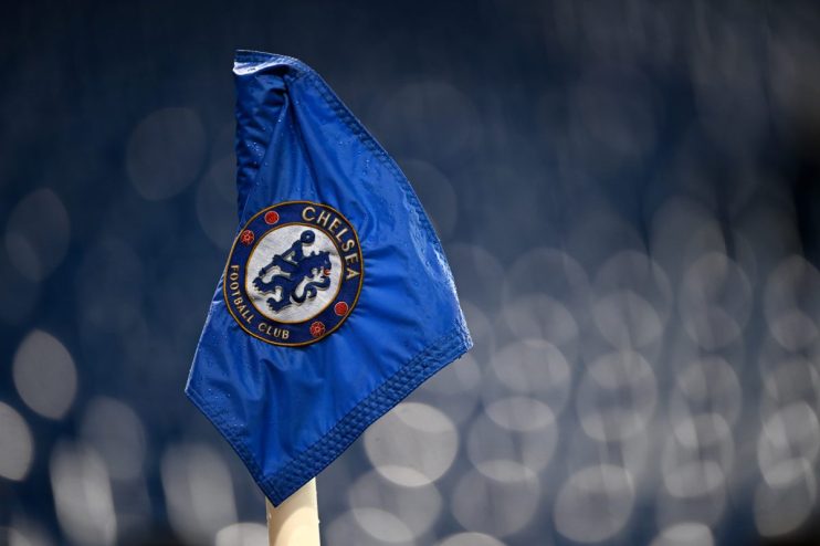 Close-up of a blue Chelsea Football Club corner flag with visible raindrops and the club crest.