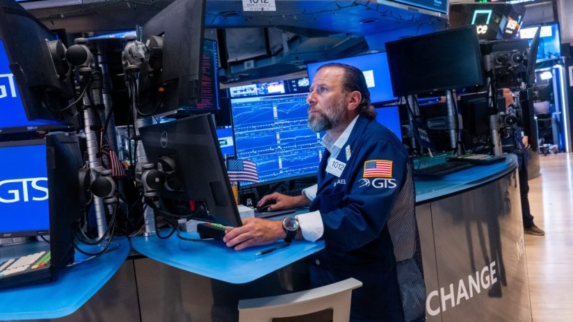 Trader Michael Pistillo at a GTS Securities workstation on the NYSE trading floor, monitors stock data.