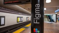Figma advertisement on a subway station column at Montgomery Street, San Francisco, with train tracks and escalator.