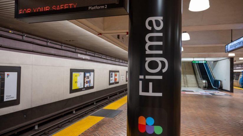 Figma advertisement on a subway station column at Montgomery Street, San Francisco, with train tracks and escalator.