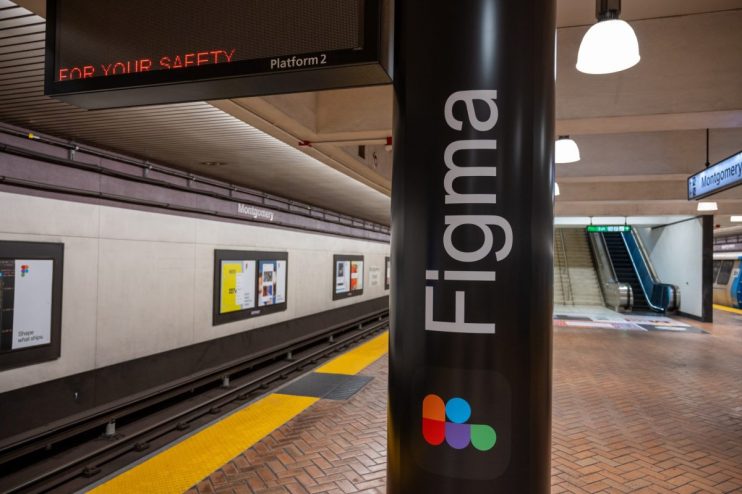 Figma advertisement on a subway station column at Montgomery Street, San Francisco, with train tracks and escalator.