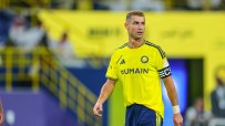Cristiano Ronaldo in a yellow Al Nassr FC jersey on a soccer field