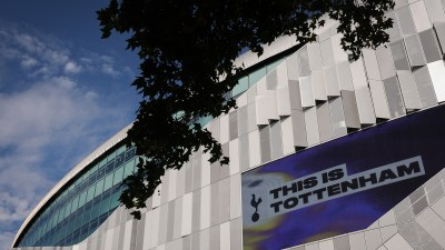 Tottenham Hotspur Stadium exterior with THIS IS TOTTENHAM on a large digital screen
