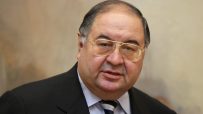 Alisher Usmanov, Russian billionaire businessman, wearing a dark suit, light blue shirt, and striped tie.
