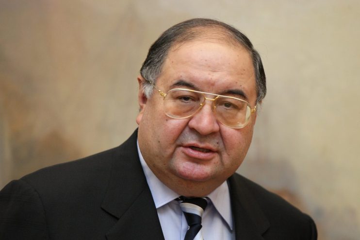 Alisher Usmanov, Russian billionaire businessman, wearing a dark suit, light blue shirt, and striped tie.