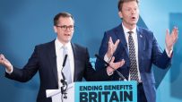 Robert Jenrick and Richard Tice speaking at podiums, blue background, Ending Benefits Britain sign.