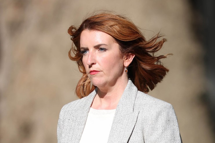 Louise Haigh, a woman with red hair and blue eyes, wearing a grey herringbone jacket.
