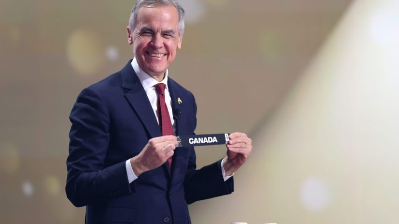 Mark Carney, former Bank of Canada Governor, smiling and holding up a CANADA sign.