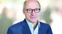 Michael Lindsell in 2022, a man wearing glasses and a blue suit jacket, for a business news context.