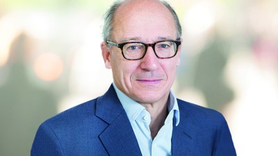 Michael Lindsell in 2022, a man wearing glasses and a blue suit jacket, for a business news context.