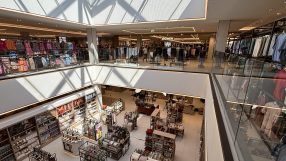 Overhead view of a modern multi-level department store interior with clothing racks and home goods displays, Bluewater.