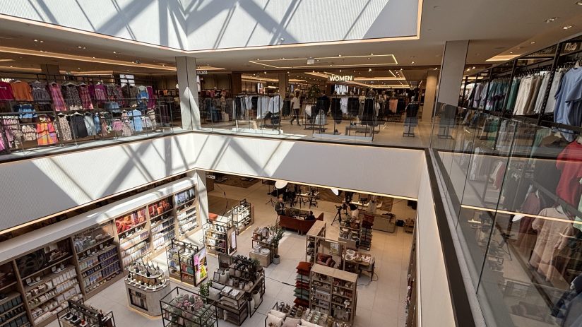 Overhead view of a modern multi-level department store interior with clothing racks and home goods displays, Bluewater.