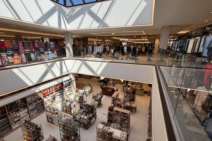 Overhead view of a modern multi-level department store interior with clothing racks and home goods displays, Bluewater.
