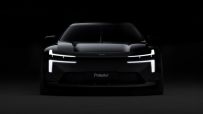 Front view of the dark Polestar electric vehicle with illuminated LED headlights and the Polestar logo.