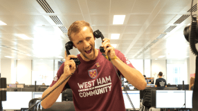 Tom&aacute;&scaron; Souček in West Ham United shirt excitedly holding two phone receivers at the BGC Charity Day