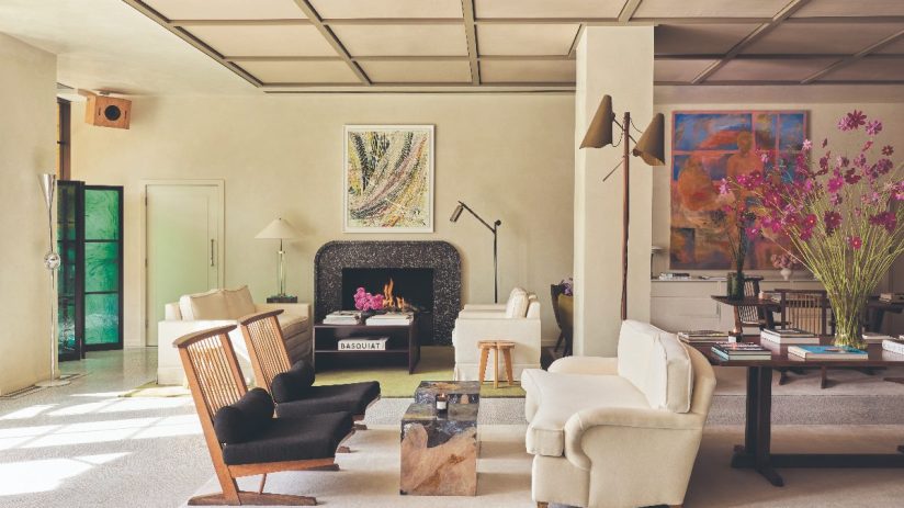 Elegant living room in a St Clement London hotel, featuring modern furniture, fireplace, and art.