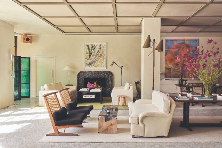 Elegant living room in a St Clement London hotel, featuring modern furniture, fireplace, and art.