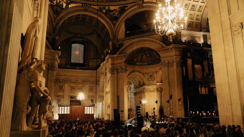 St Pauls Cathedral interior with an audience, grand architecture, chandeliers, and decorative fabric details