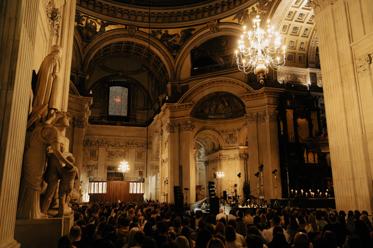 St Pauls Cathedral interior with an audience, grand architecture, chandeliers, and decorative fabric details