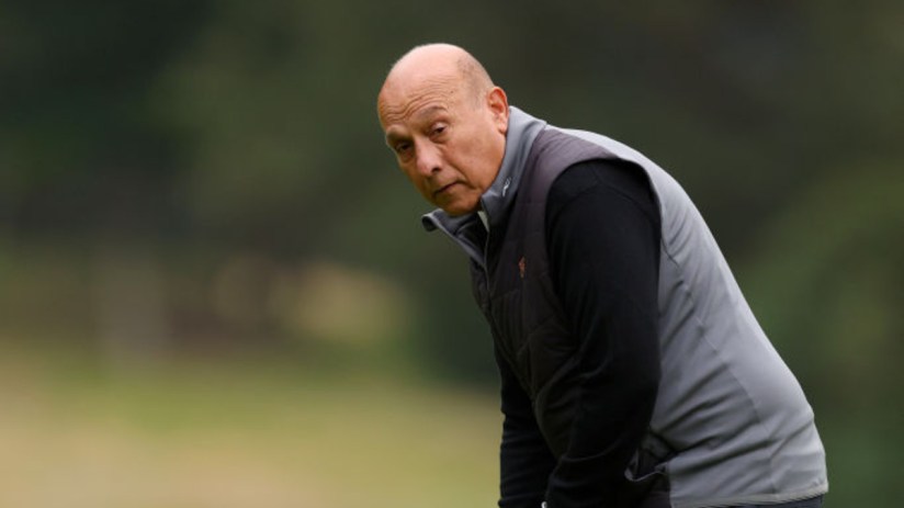 Surinder Arora, Heathrow bidder, in golf attire on a green course, looking towards the camera