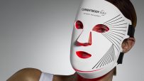 CURRENTBODY Skin LED face mask on a person, highlighting the red light therapy for beauty tech applications.