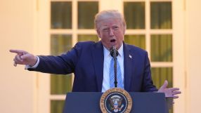 Donald Trump speaking at a podium with the Presidential Seal, pointing with his right hand