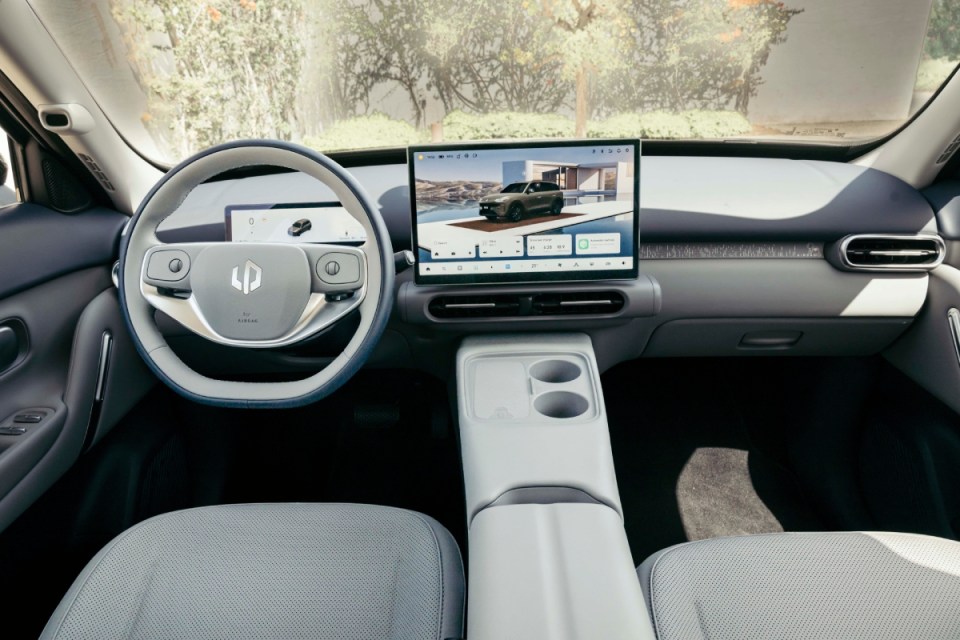 Leapmotor B03X electric vehicle interior, showing dashboard, steering wheel, large infotainment screen, and light grey seats.