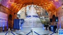 SVEDKA Martini pyramid display under string lights in an archway with Borough Yards banner