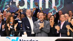 Executives and team celebrate Arm Holdings spinout on the Nasdaq exchange with confetti, Cambridge.