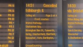 Close-up of a train station departure board showing 14:31 Cancelled for an Edinburgh service.