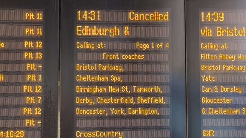 Close-up of a train station departure board showing 14:31 Cancelled for an Edinburgh service.