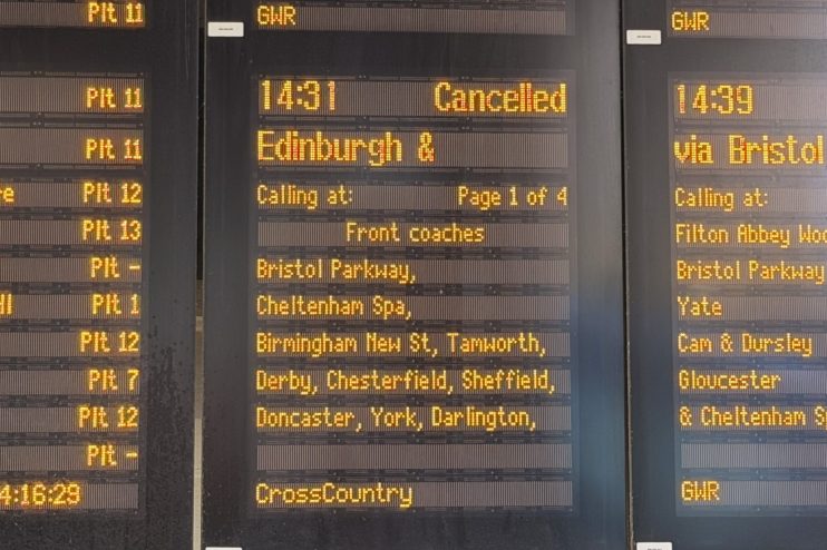 Close-up of a train station departure board showing 14:31 Cancelled for an Edinburgh service.
