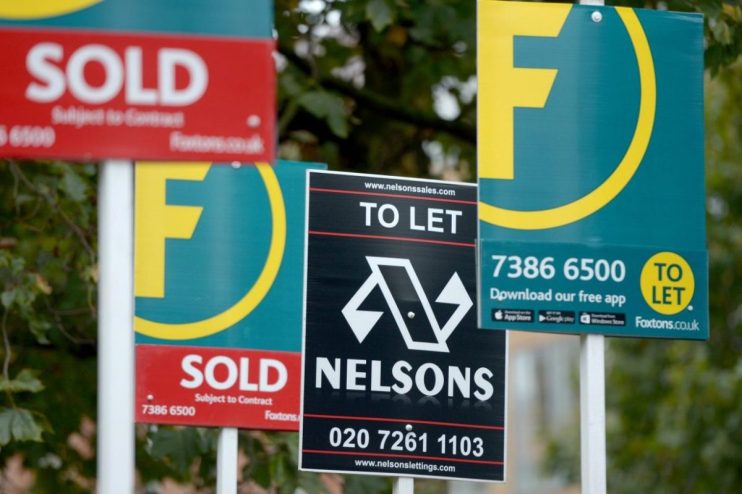 Real estate signs: SOLD (Foxtons) and TO LET (Nelsons, Foxtons), indicating property market activity.