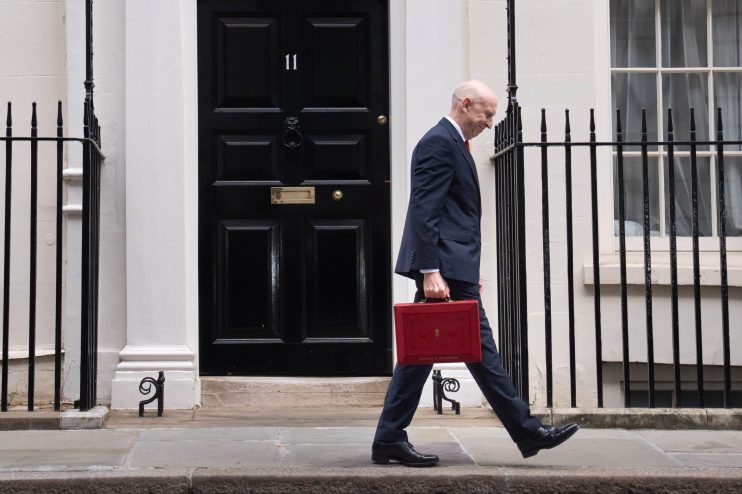 Chancellor of the Exchequer carrying the red Budget box at 11 Downing Street