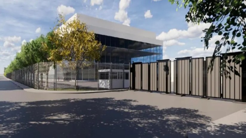 Architectural rendering of a modern AI data centre facility with a security fence, gate, and guardhouse.