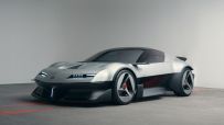 Sleek silver Alpine concept car with black trim, modern LED headlights, and unique wheel design on a concrete floor.