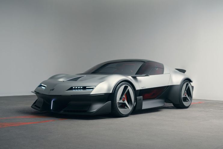 Sleek silver Alpine concept car with black trim, modern LED headlights, and unique wheel design on a concrete floor.