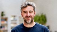 Andrew Steele, Founder at Stride, smiling at the camera with a blurred background