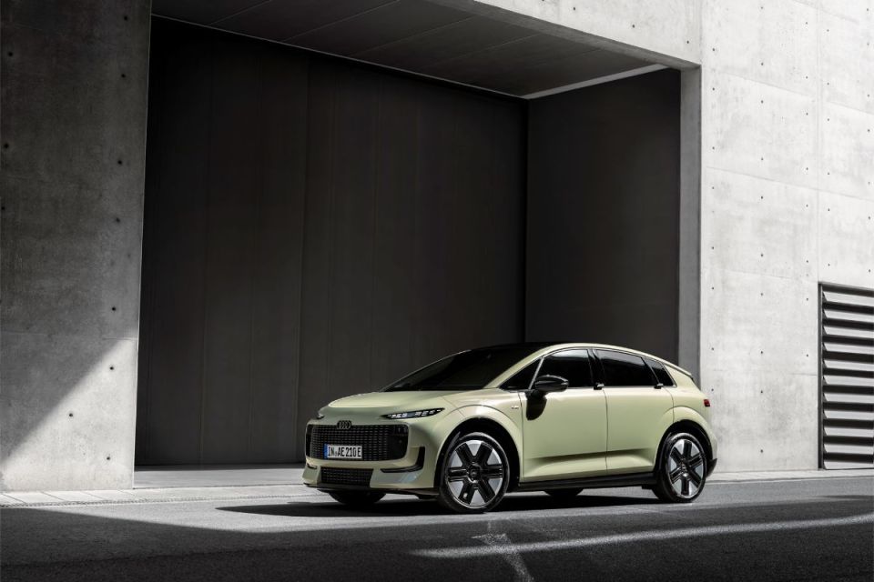 Audi A2 concept car in light green parked in a modern concrete and dark-paneled garage.