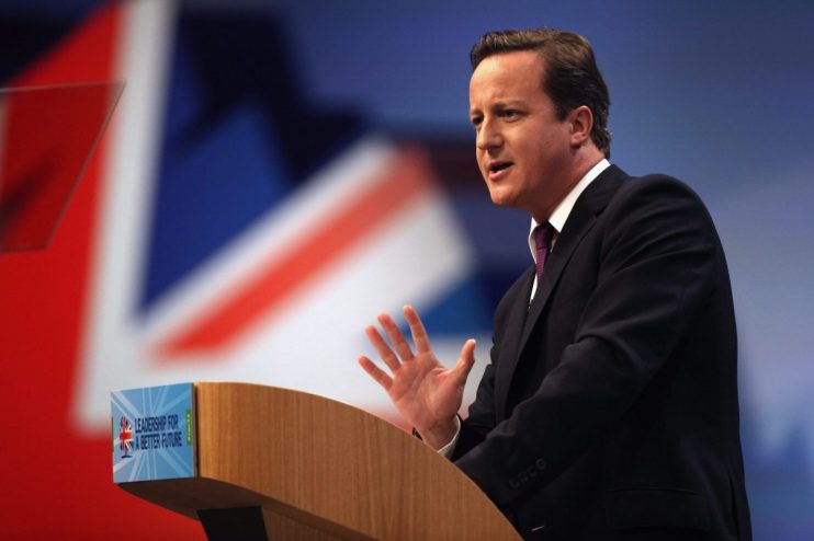 David Cameron speaking at a podium, Union Jack flag backdrop, Leadership for a Better Future visible.