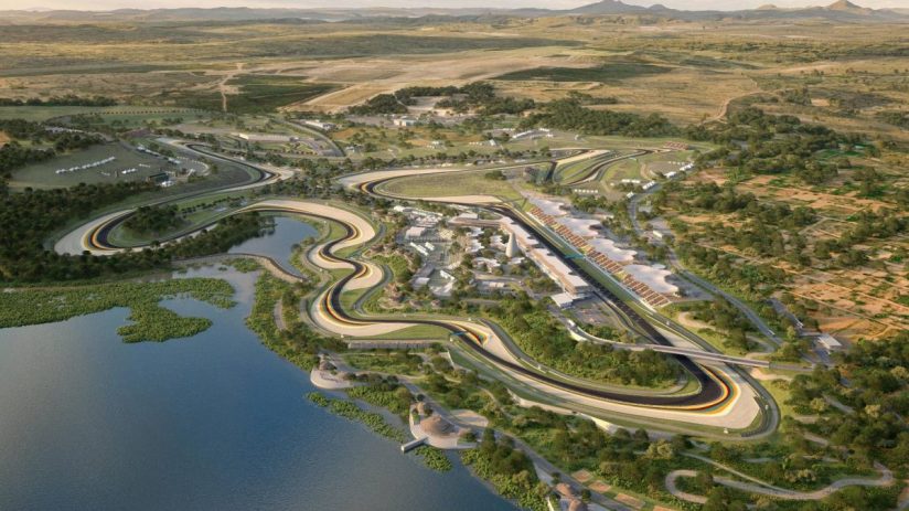 Aerial rendering of a sprawling F1 racetrack, grandstands, and support facilities beside a lake in a natural landscape.