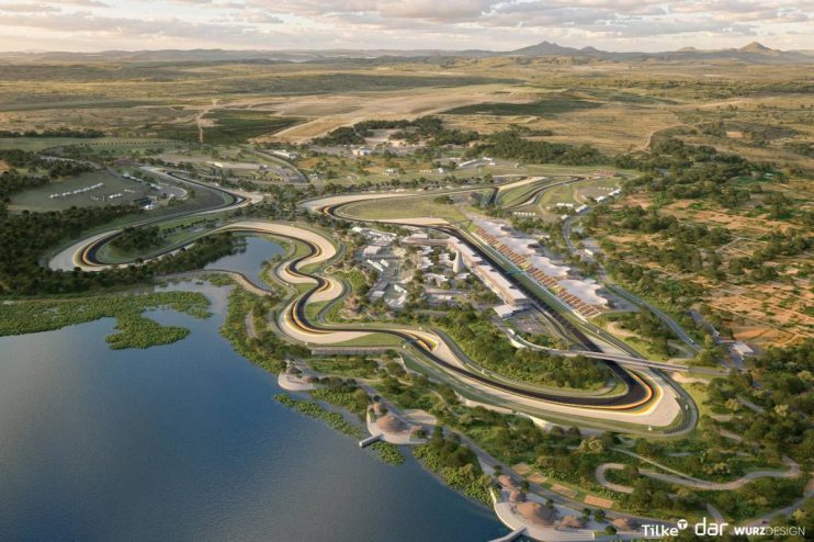 Aerial rendering of a sprawling F1 racetrack, grandstands, and support facilities beside a lake in a natural landscape.